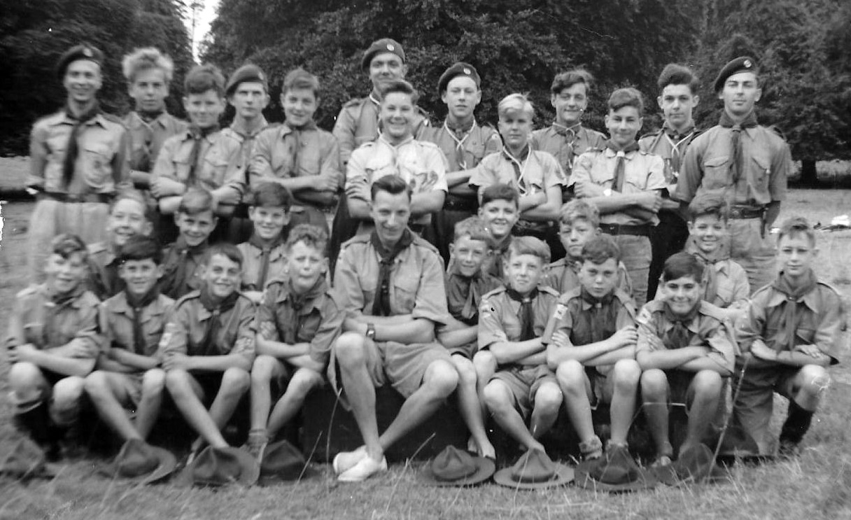 3 rows of boys and men wearing Scout uniform
