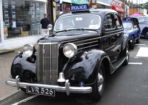 an old black police car with a bell on the front