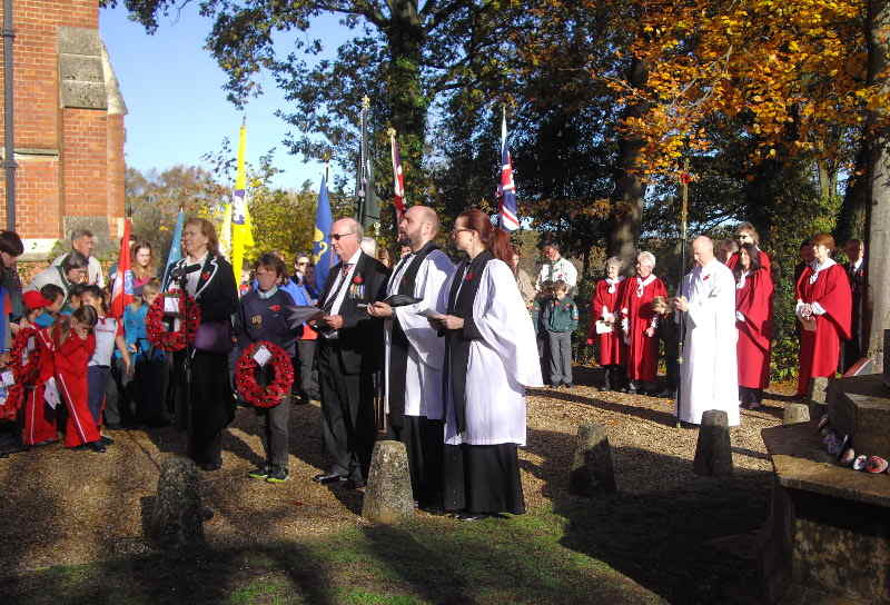 Clergy and members of youth organisations gathered by a war memorial