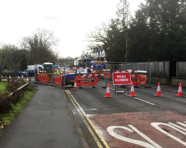 barriers and traffic cones across a road and 'road closed' sign